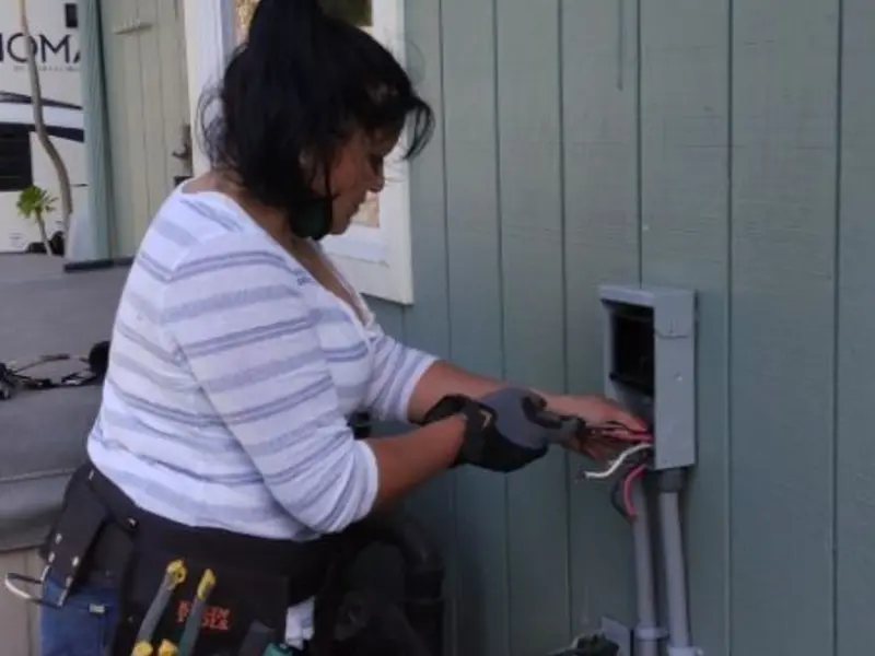 Licensed electrician wiring an exterior subpanel in Dayton